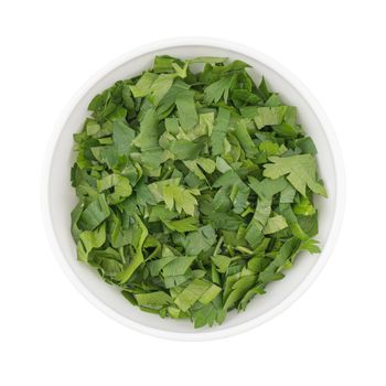bowl of chopped parsley leaves isolated on white background