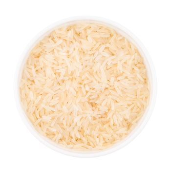 Uncooked basmati rice in a ceramic bowl on white background