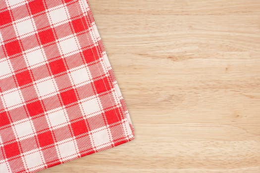 the checkered tablecloth on wooden table