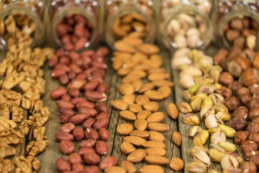 Mix of nuts in the glass jars , on the table, selective focus