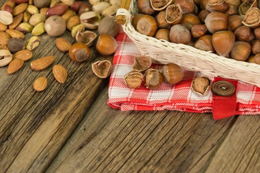Hazelnuts in small wicker basket, nut mix, selective focus