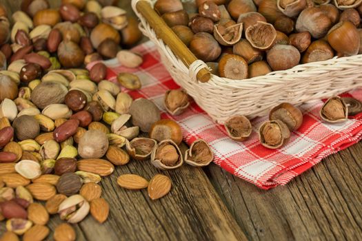 Hazelnuts in small wicker basket, nut mix, selective focus