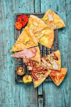Pizza stuffed with meat and baked vegetables in rustic style