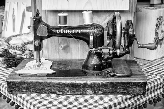 Old manual sewing machine used to embroider wooden shapes.