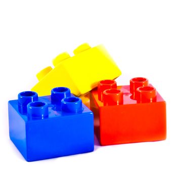 Plastic building blocks on white background. Bright colors.