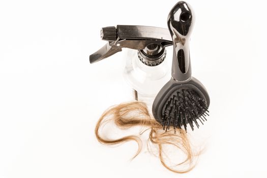 Close-up of hair loss, long hair, alopecia on white background with brush, comb nobody