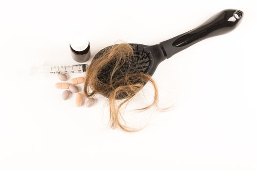 Close-up of hair loss, long hair, alopecia treatment on white background with brush