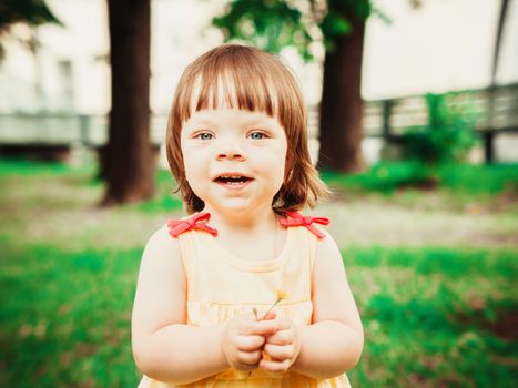 Little Baby Girl Portrait outdoor. Cute Child over nature background. Adorable one year old baby