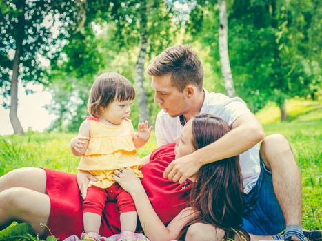 naughty little baby and parents with tired and discontented expression. Parents tired of baby concept