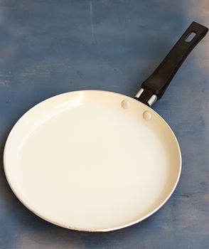 Pan bottom with white on a wooden blue background