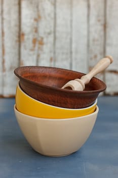 Stack of Colorful Bowls on Wooden Background