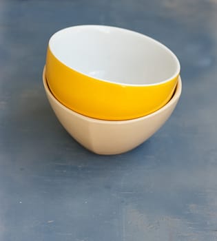 Stack of Colorful Bowls on Wooden Background