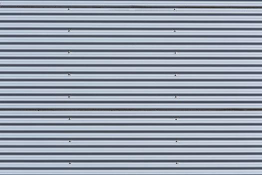 Silver-colored metal wall corrugated sheet metal background.