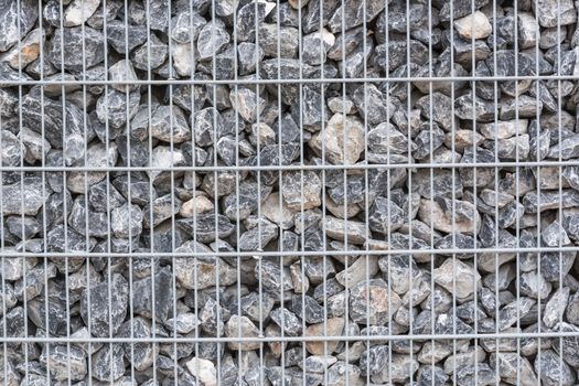 Gabion filled with thick stones; Metal Stone basket with large natural stones for external landscaping.