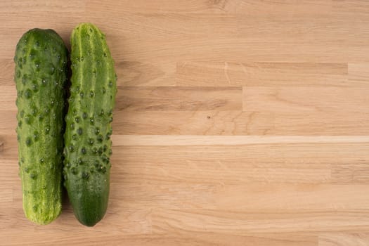 Cucumbers on a wooden background.