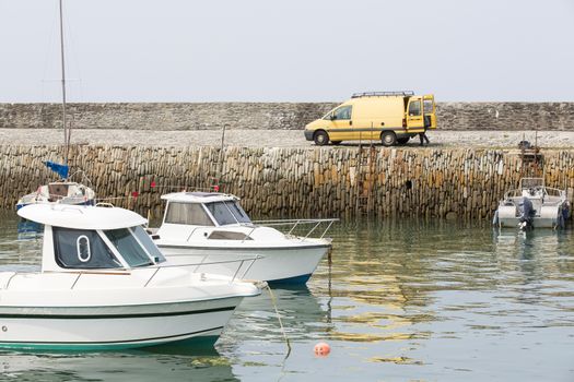 Small fishing boats waiting in port France water reflection