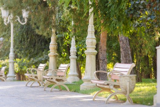 Alley with several benches in the city park "Baku" in Volgograd