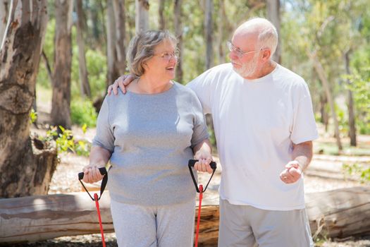 Happy Healthy Senior Couple Exercising Outside Together.