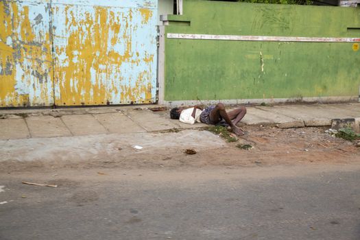 beggar, homeless sleeping in the street, India, Tamil Nadu