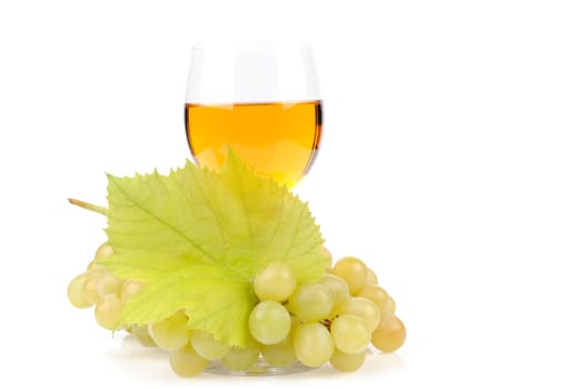 Branch of grapes and glass of wine isolated on white background