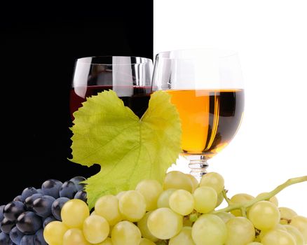 Branch of grapes and glass of wine isolated on white background