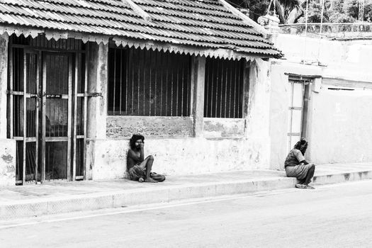 Documentary editorial image. Pondicherry, Tamil Nadu, India - June 24 2014. homeless and poor people writing, sleeping, walking in the street