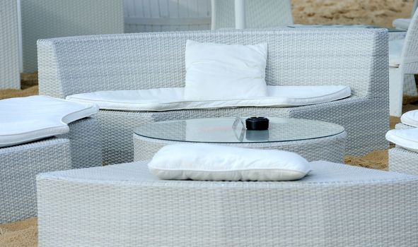 Luxury beach furniture and table on tropical island beach