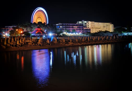 Beach street view with water reflections at night
