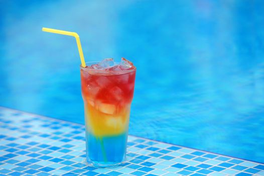 Colourful cocktail on the background of the swimming pool