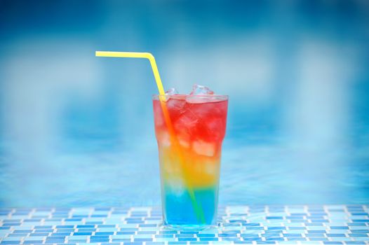 Colourful cocktail on the background of the swimming pool