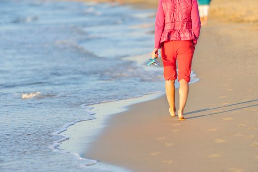 Walking on the beach in sunset time