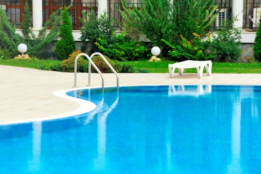 Swimming pool with stair at hotel close up