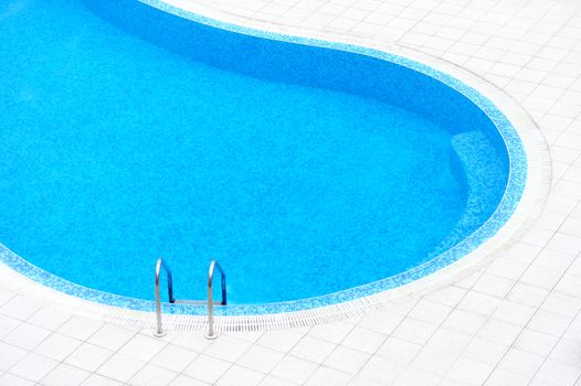 Swimming pool with stair at hotel close up