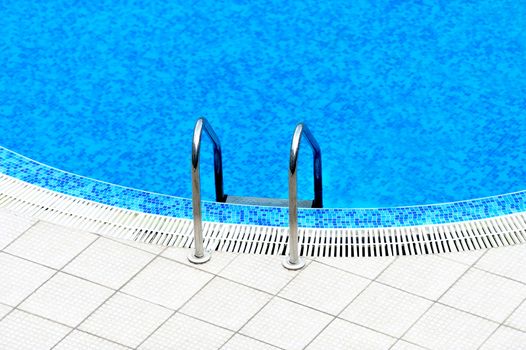 Swimming pool with stair at hotel close up