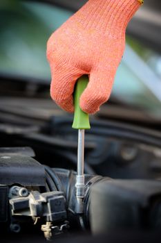 Hands of car mechanic in auto repair service