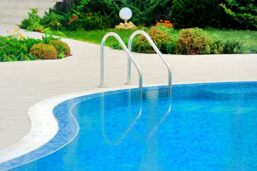 Swimming pool with stair at hotel close up