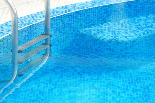 Swimming pool with stair at hotel close up