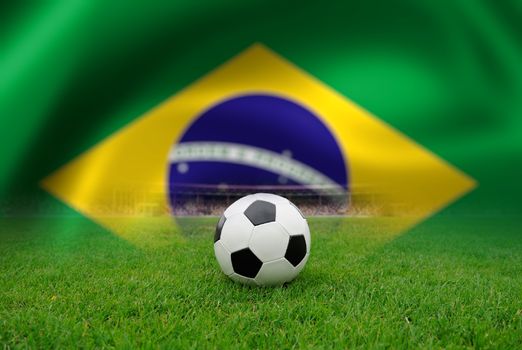 Soccer ball on the field of stadium on Brazil flag background