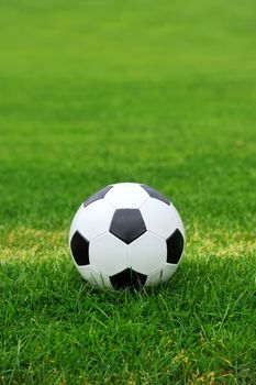 Close-up soccer ball on green grass