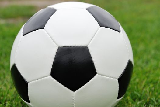 Close-up soccer ball on green grass