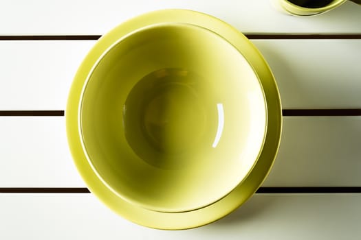 Top view empty green bowl and dish on white wood. Horizontal image.