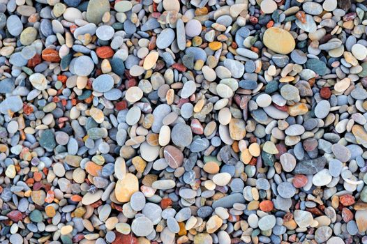 Colorful pebble stones texture by the beach