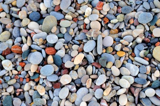 Colorful pebble stones texture by the beach