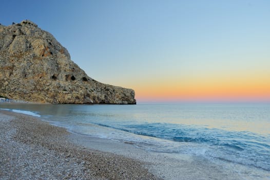 Sunset on the beach. View of the beach and mountains