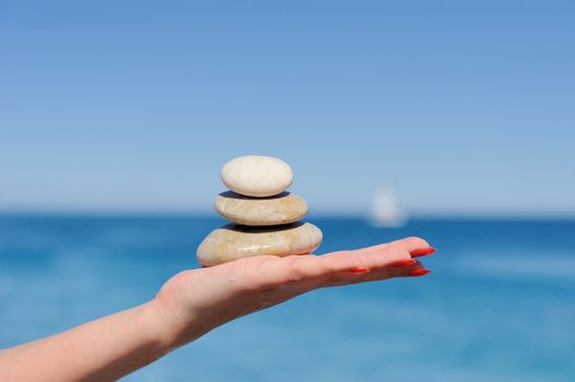 Stones in a hand on a background of the dark blue sky