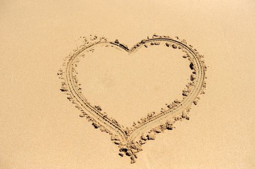 A heart shape drawn in the sand