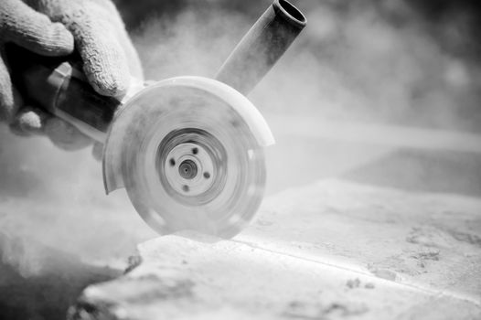 grinder worker cuts a stone the electric tool