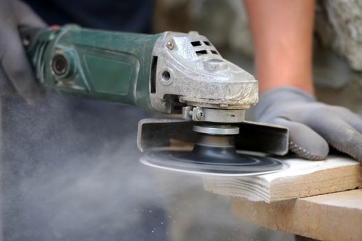 Worker polishing a wood table. Close-up