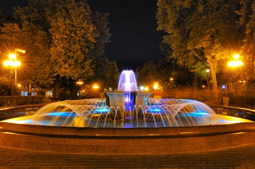 Colored water fountain at night