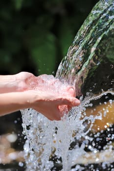 Woman's hands with water splash